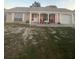 Charming single-story home with a covered porch, front yard, and attached two-car garage at 4150 Woodsville Dr, New Port Richey, FL 34652