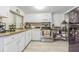 Well-lit kitchen featuring modern appliances, granite countertops, and ample storage space in white cabinetry at 4150 Woodsville Dr, New Port Richey, FL 34652