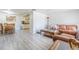 Open living space with light grey flooring, leather couches, and dining area with a table and chairs at 4150 Woodsville Dr, New Port Richey, FL 34652