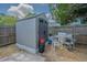 Backyard shed with grill and chairs, offering ample storage and outdoor entertaining space at 4150 Woodsville Dr, New Port Richey, FL 34652