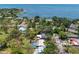 An aerial view of the home with pool, lush trees, and its proximity to a nearby bay or ocean at 417 66Th S Ave, St Petersburg, FL 33705