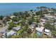 An aerial view of a residential area showcasing tree coverage and houses near the coast at 417 66Th S Ave, St Petersburg, FL 33705