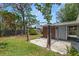 Backyard with an outdoor structure and concrete pad, perfect for entertaining or relaxing outdoors at 417 66Th S Ave, St Petersburg, FL 33705