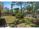 Well-maintained backyard featuring a mix of grass and natural landscaping, and a fenced perimeter at 417 66Th S Ave, St Petersburg, FL 33705