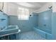 Colorful bathroom with blue tile, tub, and sink at 417 66Th S Ave, St Petersburg, FL 33705