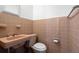 Retro-style bathroom with a pink tile and classic fixtures, creating a unique and vintage appeal at 417 66Th S Ave, St Petersburg, FL 33705