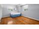 Bedroom with hardwood floors and two windows at 417 66Th S Ave, St Petersburg, FL 33705