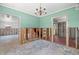 Dining area featuring a chandelier and an open layout leading to other rooms, with exposed studs at 417 66Th S Ave, St Petersburg, FL 33705