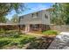 Charming two-story home with brick accents, a well-manicured lawn, and a welcoming walkway at 417 66Th S Ave, St Petersburg, FL 33705