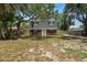 Traditional two-story home with brick accents, dormer windows, and mature trees in a spacious yard at 417 66Th S Ave, St Petersburg, FL 33705