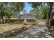 Classic home with a brick facade, dormer windows, a long driveway, and established landscaping at 417 66Th S Ave, St Petersburg, FL 33705