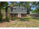 Quaint two-story home with classic brickwork, dormer windows, and lush greenery surrounding the property at 417 66Th S Ave, St Petersburg, FL 33705