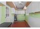 Practical utility room equipped with a water heater, storage cabinets, and convenient work space at 417 66Th S Ave, St Petersburg, FL 33705