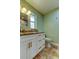 Bright bathroom featuring white cabinets, granite counters and a tile floor at 4174 14Th Ne Ln, St Petersburg, FL 33703