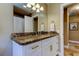 Bathroom vanity with a granite countertop, white cabinets, and modern fixtures at 4174 14Th Ne Ln, St Petersburg, FL 33703