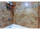 Tiled shower with glass mosaic accents in a neutral-toned bathroom at 4174 14Th Ne Ln, St Petersburg, FL 33703