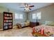 Bright bedroom featuring twin beds, a bookshelf and tile flooring at 4174 14Th Ne Ln, St Petersburg, FL 33703