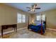 Bedroom with stylish tile floors, shuttered windows, and a four-poster bed at 4174 14Th Ne Ln, St Petersburg, FL 33703