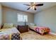 Cozy bedroom features twin beds, tiled floor and ceiling fan with light fixture at 4174 14Th Ne Ln, St Petersburg, FL 33703