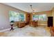 Dining room with tile floors, large windows, and a contemporary light fixture at 4174 14Th Ne Ln, St Petersburg, FL 33703