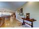 Open-concept home with travertine flooring and a decorative accent table as you enter the home at 4174 14Th Ne Ln, St Petersburg, FL 33703