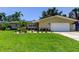 Attractive single-Gathering home with manicured landscaping, an attached garage, and a welcoming entrance at 4174 14Th Ne Ln, St Petersburg, FL 33703