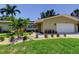 Inviting front yard of a single Gathering home with lush landscaping and a well-manicured lawn at 4174 14Th Ne Ln, St Petersburg, FL 33703