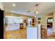 Open concept kitchen with white cabinetry, stainless steel appliances and tile flooring at 4174 14Th Ne Ln, St Petersburg, FL 33703