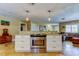 Kitchen island with stainless steel oven, pendant lights, and granite countertop at 4174 14Th Ne Ln, St Petersburg, FL 33703