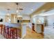 Open kitchen layout with bar seating, stainless steel appliances, and travertine floors at 4174 14Th Ne Ln, St Petersburg, FL 33703