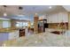 Modern kitchen with stainless steel appliances, white cabinets, and granite countertops at 4174 14Th Ne Ln, St Petersburg, FL 33703
