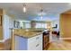 Kitchen island with built-in oven, granite countertop, and view of the living room at 4174 14Th Ne Ln, St Petersburg, FL 33703