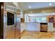 Kitchen featuring stainless steel refrigerator, white cabinets, and granite countertops at 4174 14Th Ne Ln, St Petersburg, FL 33703