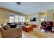 Comfortable living room featuring tile floors, shutters on the windows, and an oversized couch at 4174 14Th Ne Ln, St Petersburg, FL 33703