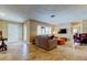 Bright living room featuring travertine flooring, a comfortable sectional, and access to other rooms at 4174 14Th Ne Ln, St Petersburg, FL 33703