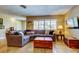 Comfortable living room with travertine flooring, a large window, and a cozy sectional sofa at 4174 14Th Ne Ln, St Petersburg, FL 33703