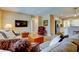 Open concept living room into the kitchen featuring travertine floors, large sectional, and a red leather chair at 4174 14Th Ne Ln, St Petersburg, FL 33703