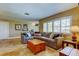 Comfortable living room featuring tile floors, large windows, and a neutral-toned couch at 4174 14Th Ne Ln, St Petersburg, FL 33703