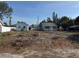 A quaint cottage-style home with a detached garage sits on a lot that awaits landscaping at 4419 Burlington N Ave, St Petersburg, FL 33713