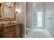 Elegant bathroom features custom vanity with marble countertop, decorative mirror, and natural light at 4512 Cheval Blvd, Lutz, FL 33558