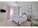 Charming bedroom featuring four-poster bed with canopy, and soft pink accents at 4512 Cheval Blvd, Lutz, FL 33558