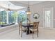 Dining area with large windows offering views of the pool and backyard at 4512 Cheval Blvd, Lutz, FL 33558