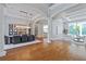 Open dining area with modern chandelier, hardwood floors, and views to the living room at 4512 Cheval Blvd, Lutz, FL 33558