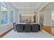 Dining room with tray ceiling, bright windows, modern chandelier, and hardwood floors at 4512 Cheval Blvd, Lutz, FL 33558