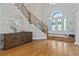 Spacious foyer featuring hardwood floors, grand staircase, and stylish console table at 4512 Cheval Blvd, Lutz, FL 33558