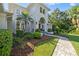 Inviting entrance with manicured landscaping and a brick walkway to the front door at 4512 Cheval Blvd, Lutz, FL 33558