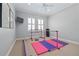Well-lit home gym features padded mats, equipment, and natural light through shuttered windows at 4512 Cheval Blvd, Lutz, FL 33558