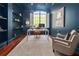 Well-lit home office with dark blue walls and hardwood floors at 4512 Cheval Blvd, Lutz, FL 33558