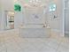 Relax in the elegant primary bath featuring a large corner jetted tub and chandelier at 4512 Cheval Blvd, Lutz, FL 33558