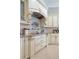 Chef's kitchen with custom cabinets, stone countertops, and high-end appliances and custom range hood at 4512 Cheval Blvd, Lutz, FL 33558